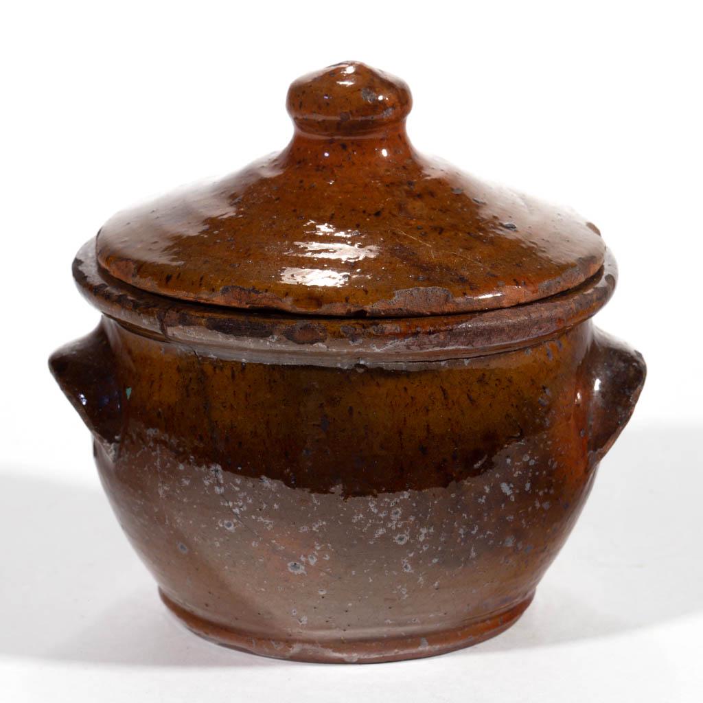 MID-ATLANTIC EARTHENWARE / REDWARE DIMINUTIVE SUGAR: MID-ATLANTIC EARTHENWARE / REDWARE DIMINUTIVE SUGAR BOWL WITH COVER, ovoid form with flattened rim, arched tab handles, and pronounced foot, cover with inner flange and button finial. Probably Marylan
