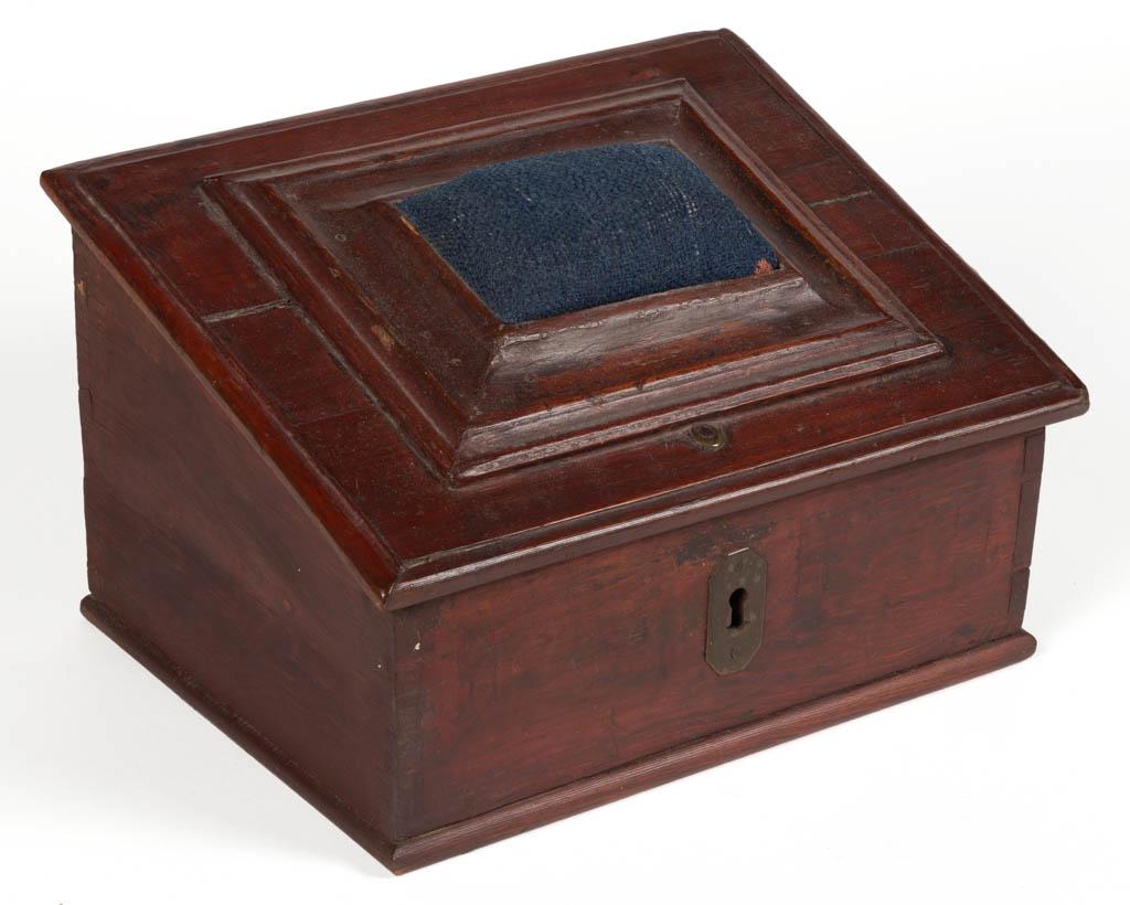 COUNTRY PAINTED PINE SEWING BOX: COUNTRY PAINTED PINE SEWING BOX, strap-hinged slant-front with pincushion, concealing open interior with applied heart pincushion and lidded till, dovetailed case with brass escutcheon. Retains an old