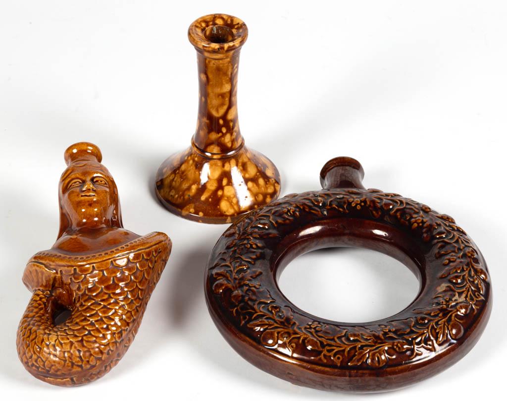 ASSORTED ROCKINGHAM-GLAZE POTTERY ARTICLES, LOT OF: ASSORTED ROCKINGHAM-GLAZE POTTERY ARTICLES, LOT OF THREE, mottled brown, comprising a flask with mermaid form, a ring jug/flask with relief oak leaf and acorn design to one side and fruit and vine to