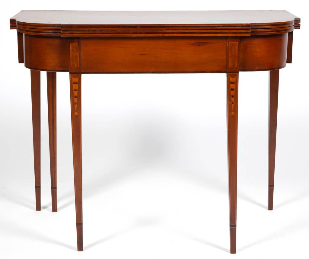 VERMONT INLAID FEDERAL CHERRY CARD / GAMES TABLE: VERMONT INLAID FEDERAL CHERRY CARD / GAMES TABLE, shaped, hinged folding top, raised on square-tapered legs with banded cuffs, five-legs, one of which swings out to support the hinged leaf, featuring 