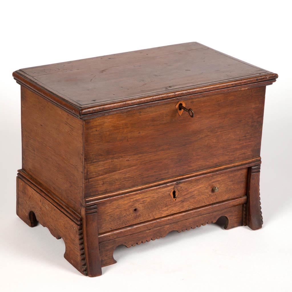 AMERICAN WALNUT MINIATURE BLANKET CHEST: AMERICAN WALNUT MINIATURE BLANKET CHEST, hinged rectangular lid with applied molded edge, concealing an open interior with till, and lined with wallpaper, over full-length drawer with likely original 