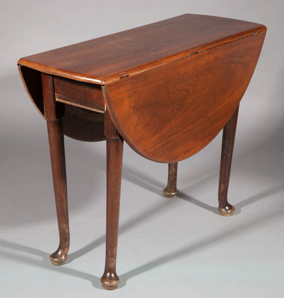 GEORGIAN WALNUT FALL-LEAF DINING TABLE: GEORGIAN WALNUT FALL-LEAF DINING TABLE, oval top with two hinged-leaves, raised on four round-tapered legs terminating in pad feet, two of which swivel to support the leaves. Oak secondary wood. Old r