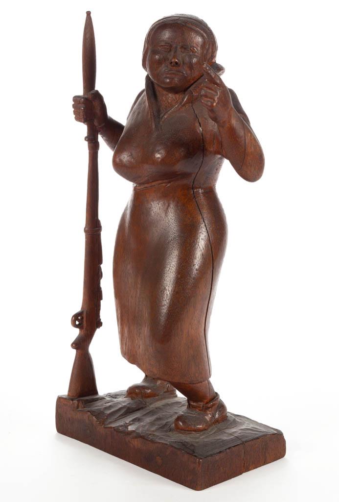 AMERICAN FOLK ART CARVED WOODEN PATRIOTIC FIGURE: AMERICAN FOLK ART CARVED WOODEN PATRIOTIC FIGURE, two-piece pegged construction, possibly depicting Mary Hays, aka "Molly Pitcher" of American Revolutionary War lore, holding a gun with bayonet. Retai