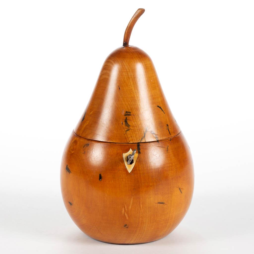 GEORGIAN FRUITWOOD PEAR-FORM TEA CADDY: GEORGIAN FRUITWOOD PEAR-FORM TEA CADDY, a large example having hinged lid with possibly original stem finial, inlaid shield-form bone escutcheon, zinc-lined interior, retaining original lock and key. 
