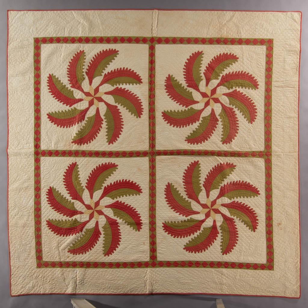 AMERICAN "PRINCESS FEATHER" APPLIQUE AND PIECED QUILT: AMERICAN "PRINCESS FEATHER" APPLIQUE AND PIECED QUILT, hand-stitched, green and yellow printed fabrics and solid red fabric on plain white, four applique pattern blocks, encompassed by a pieced diamon