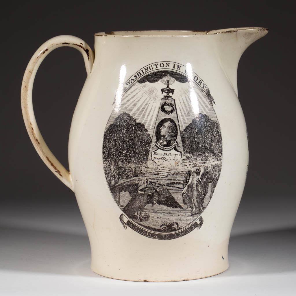 ENGLISH HERCULANEUM CREAMWARE TRANSFER-PRINTED AMERICAN: ENGLISH HERCULANEUM CREAMWARE TRANSFER-PRINTED AMERICAN HISTORICAL / GEORGE WASHINGTON CERAMIC JUG / PITCHER, having black transfer images, one side featuring "WASHINGTON IN GLORY." with a woman and e
