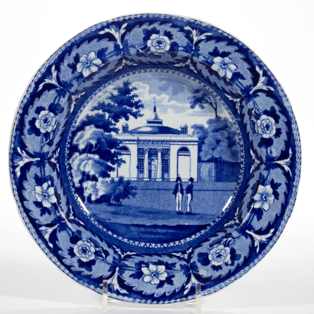 ENGLISH STAFFORDSHIRE PEARLWARE TRANSFER-PRINTED: ENGLISH STAFFORDSHIRE PEARLWARE TRANSFER-PRINTED AMERICAN VIEW CERAMIC SOUP PLATE, having dark blue transfer featuring Staughton's Baptist Church designed by John Mills, with two figures in top hats i