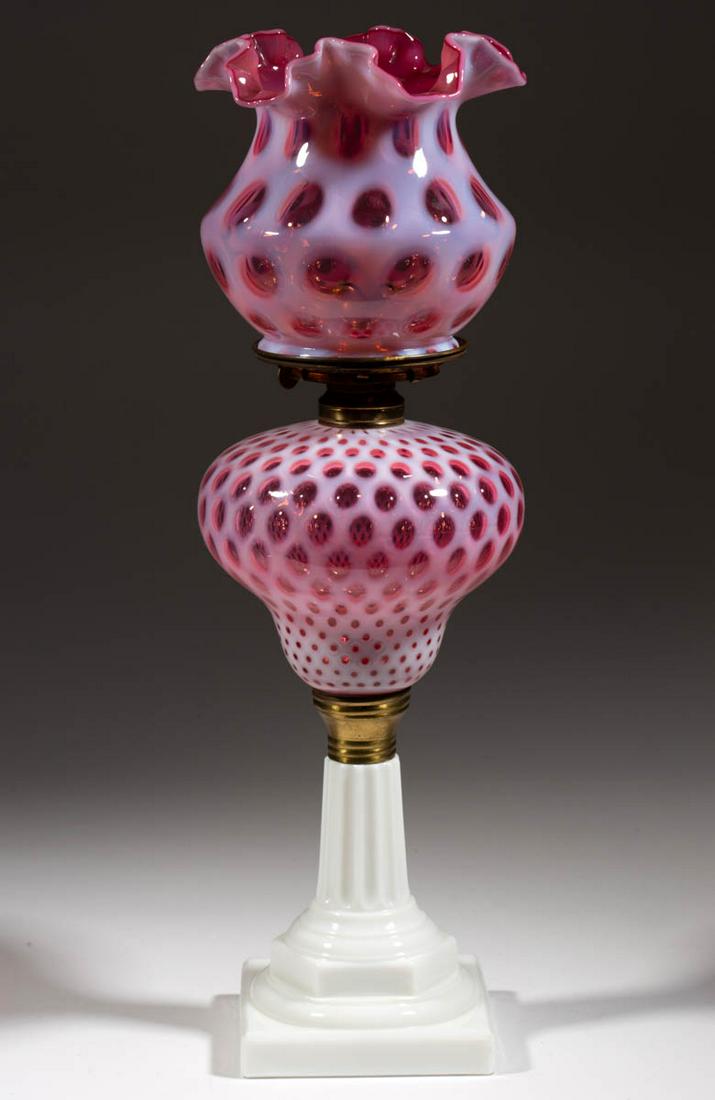 L. G. WRIGHT HONEYCOMB / COIN DOT KEROSENE STAND LAMP: L. G. WRIGHT HONEYCOMB / COIN DOT KEROSENE STAND LAMP, cranberry opalescent font, opaque white base and brass connector, No. 2 brass collar. Fitted with a brass No. 2 Victor slip burner, matching patt