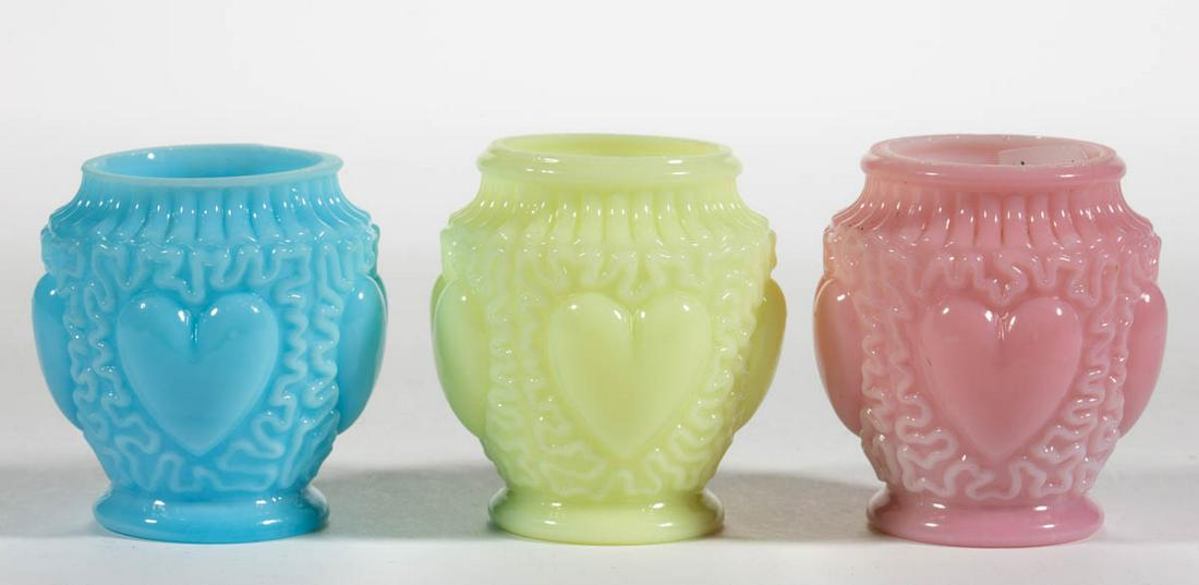 DITHRIDGE NO. 59 / HEART TOOTHPICK HOLDERS, LOT OF: DITHRIDGE NO. 59 / HEART TOOTHPICK HOLDERS, LOT OF THREE, ivory/custard (reacts under black light), opal-cased pink, and opaque blue, factory ground rims. Dithridge & Co. Pattern introduced in 1894. 2