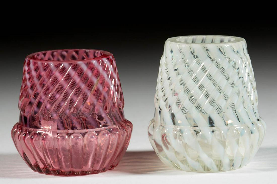 CHRYSANTHEMUM SWIRL TOOTHPICK HOLDERS, LOT OF TWO: CHRYSANTHEMUM SWIRL TOOTHPICK HOLDERS, LOT OF TWO, comprising a cranberry opalescent and a colorless opalescent. Northwood Glass Co./Buckeye Glass Co. Circa 1890. 2" and 2 1/8" H. Undamaged. Each havi