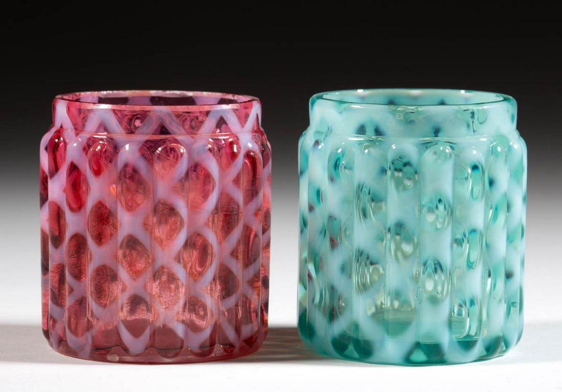 RIBBED OPAL LATTICE TOOTHPICK HOLDERS, LOT OF TWO: RIBBED OPAL LATTICE TOOTHPICK HOLDERS, LOT OF TWO, blue opalescent and cranberry opalescent, each having a factory-polished rim. Maker unverified, possibly Northwood Glass Co. Circa 1888. 2 1/8" H.Blu