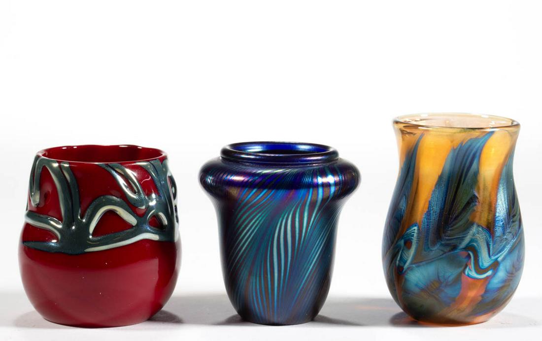 LOTTON STUDIOS ART GLASS TOOTHPICK HOLDERS, LOT OF: LOTTON STUDIOS ART GLASS TOOTHPICK HOLDERS, LOT OF THREE, comprising a blue iridescent pulled feather, a marigold iridescent with blue iridescent floral decoration, and ruby lava example with blue/pla
