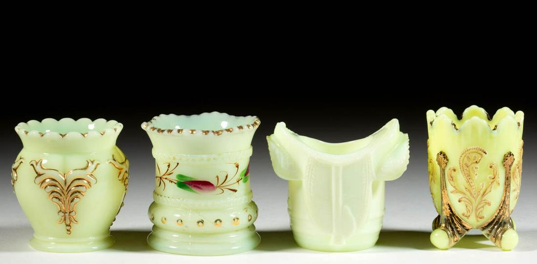 ASSORTED PRESSED CUSTARD GLASS TOOTHPICK HOLDERS, LOT: ASSORTED PRESSED CUSTARD GLASS TOOTHPICK HOLDERS, LOT OF FOUR, comprising a Heisey Winged Scroll, a reproduction Inverted Fan and Feather with stained decoration, a Ring Band, and a reproduction Saddl