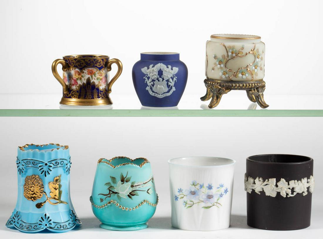 ASSORTED TOOTHPICK HOLDERS, LOT OF SEVEN: ASSORTED TOOTHPICK HOLDERS, LOT OF SEVEN, various colors, including a reproduction Chrysanthemum Sprig, a Wave Crest Short Cylinder fitted in a brass base, and a Beaded Swag with polychrome-enamel dec