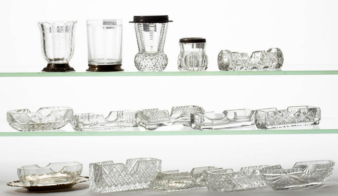 ASSORTED CUT / ENGRAVED GLASS TOOTHPICK HOLDERS, LOT OF: ASSORTED CUT / ENGRAVED GLASS TOOTHPICK HOLDERS, LOT OF 15, colorless, including 11 sanitary style, one with .800 silver tray, two with Sterling/.800 silver foot. 20th century. 1" to 2 5/8" H.Undamage