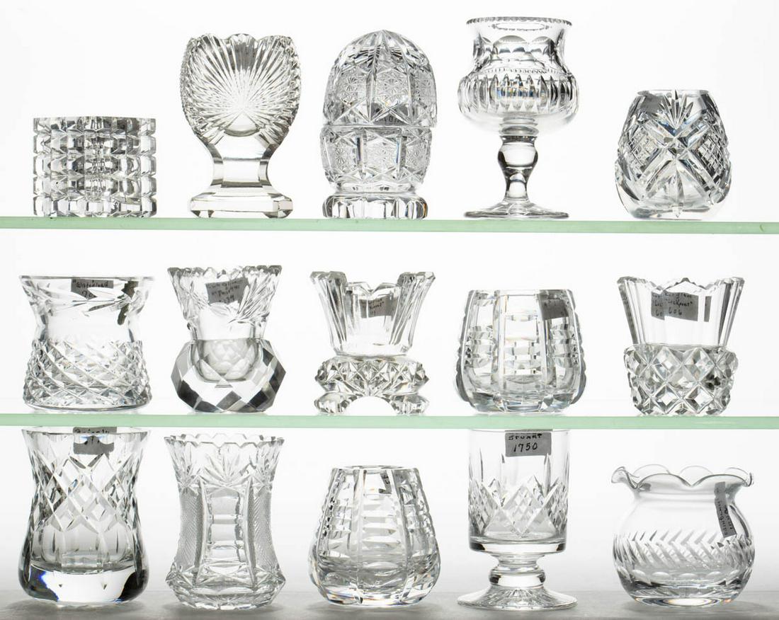 ASSORTED CUT GLASS TOOTHPICK HOLDERS, LOT OF 15: ASSORTED CUT GLASS TOOTHPICK HOLDERS, LOT OF 15, colorless, various geometric patterns, one with intaglio thistle decoration, including two pedestaled and three footed examples, one egg-form with cove
