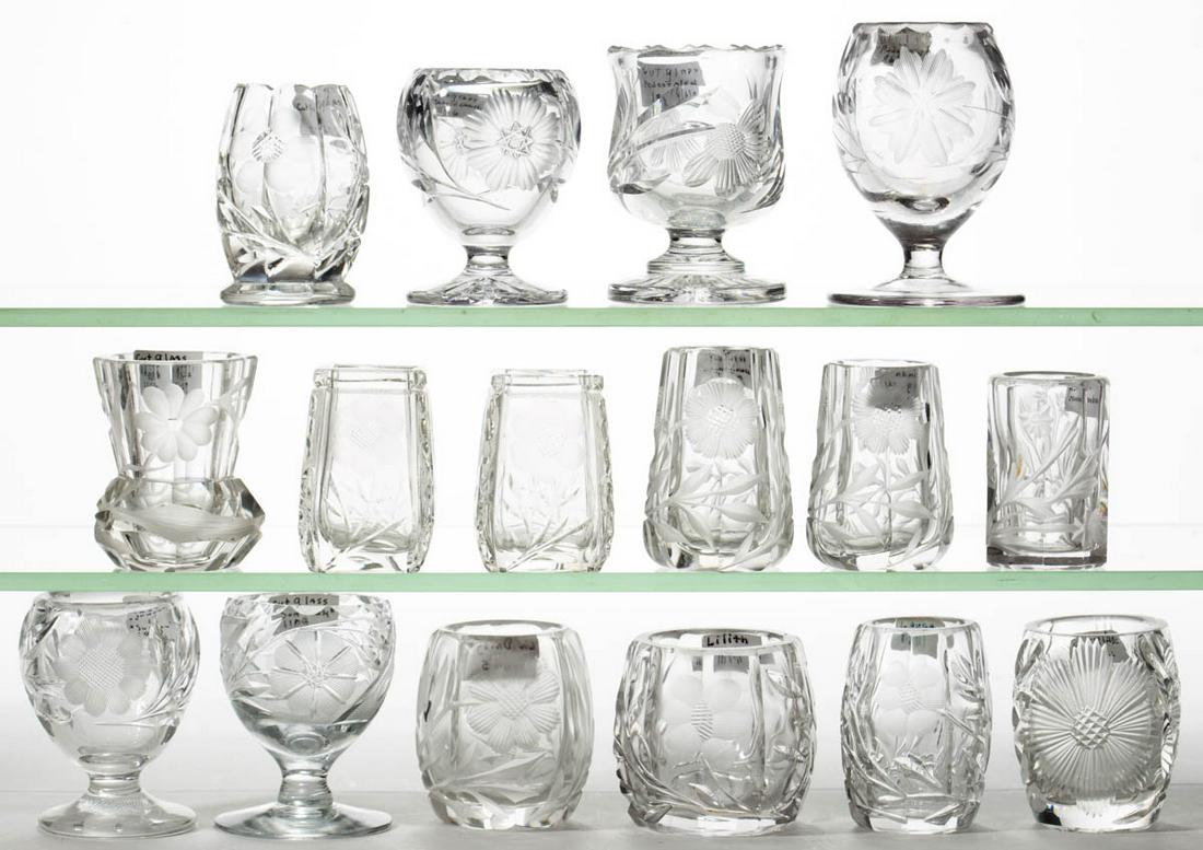 ASSORTED ENGRAVED / INTAGLIO GLASS TOOTHPICK HOLDERS,: ASSORTED ENGRAVED / INTAGLIO GLASS TOOTHPICK HOLDERS, LOT OF 16, colorless, various foliate patterns, including five pedestaled examples. 20th century. 2 1/4" to 3 1/4" H.One pedestaled example with p