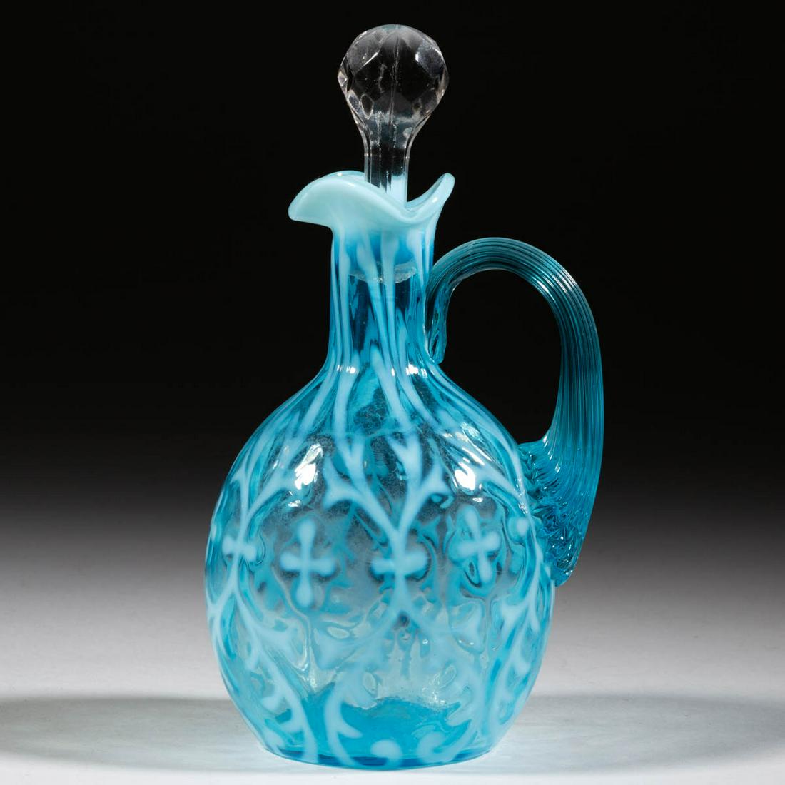 OPALINE BROCADE / SPANISH LACE CRUET: OPALINE BROCADE / SPANISH LACE CRUET, blue opalescent, colorless pressed-facet stopper, applied blue reeded handle, plain base. Northwood Glass Co. Circa 1899. 7 1/4" HOA, 5 3/4" H bottle.Cruet undama