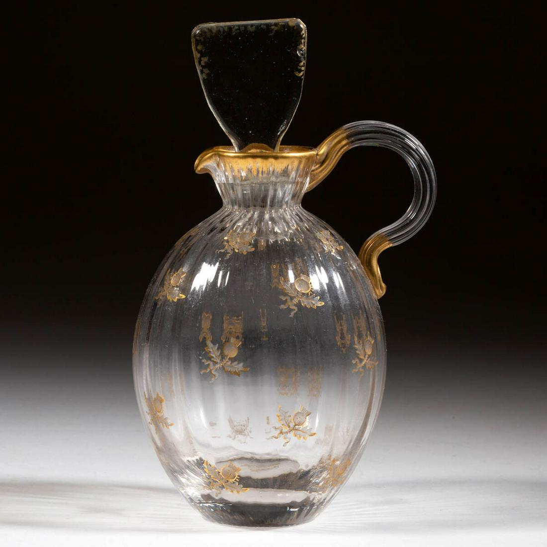 DAUM PANEL-OPTIC AND THISTLE ENGRAVED CRUET: DAUM PANEL-OPTIC AND THISTLE ENGRAVED CRUET, colorless with gilt decoration, ovoid-form with scattered engraved thistles, applied colorless reeded handle, original fan stopper, polished pontil mark, s