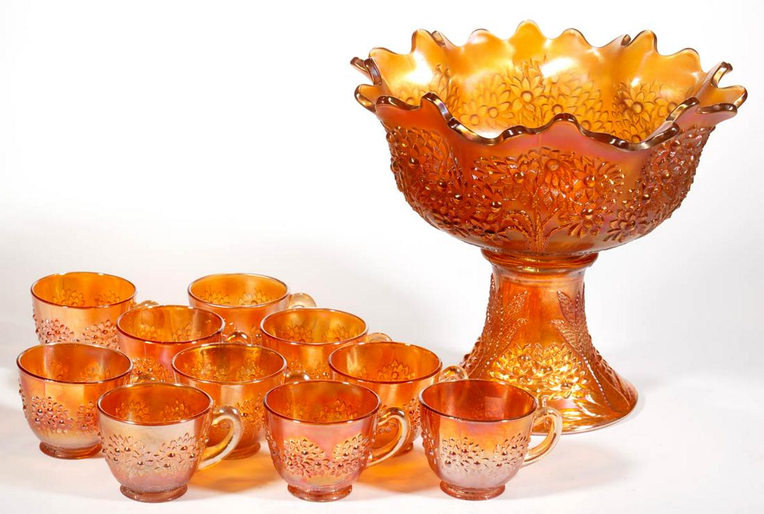 FENTON ORANGE TREE CARNIVAL GLASS 11-PIECE PUNCH SET: FENTON ORANGE TREE CARNIVAL GLASS 11-PIECE PUNCH SET, marigold iridescent, comprising a flared-rim punch bowl, pedestal base of a lighter shade and soft iridescence, and ten cups. Fenton Glass Co. Cir