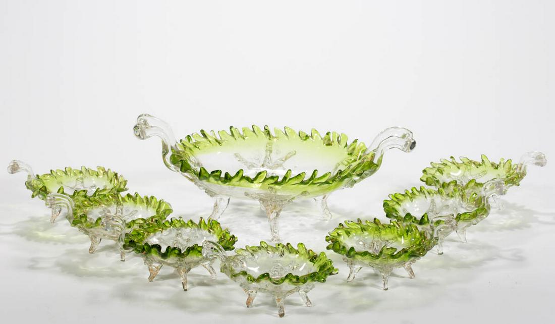 BOHEMIAN GLASS EIGHT-PIECE BERRY SET: BOHEMIAN GLASS EIGHT-PIECE BERRY SET, shaded green with some gilt decoration, comprising a four-footed and double-handled master berry bowl with seven matching individual sauce dishes. Maker unverifie