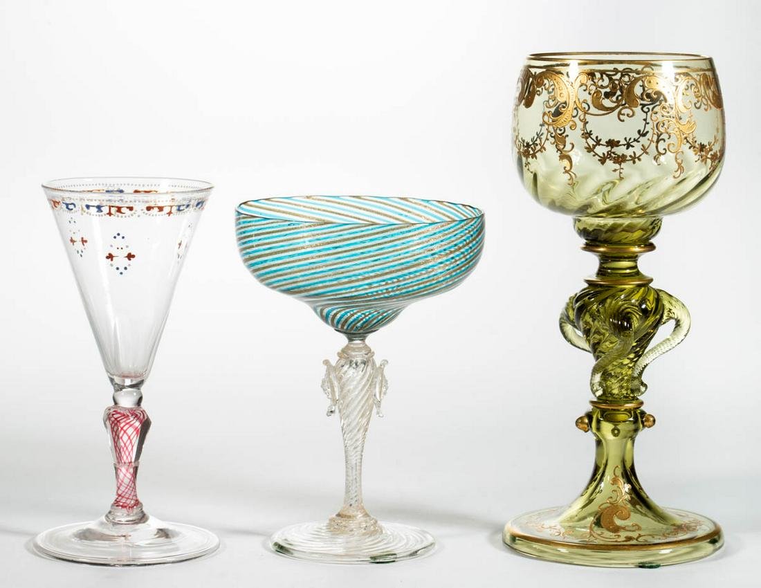 ASSORTED BOHEMIAN DECORATED DRINKING ARTICLES, LOT OF: ASSORTED BOHEMIAN DECORATED DRINKING ARTICLES, LOT OF TWO, comprising a colorless ruby-twist stem, trumpet bowl with enamel decoration, and a large olive green goblet with a complex twisted stem and f