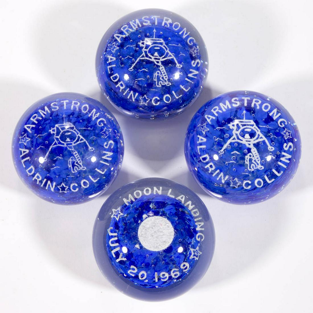 ASSORTED APOLLO 11 FRIT PAPERWEIGHTS, LOT OF FOUR: ASSORTED APOLLO 11 FRIT PAPERWEIGHTS, LOT OF FOUR, comprising three examples stating "ARMSTRONG/COLLINS/ALDRIN", each depicting the moment Armstrong stepped onto the moon, and an example stating "MOON