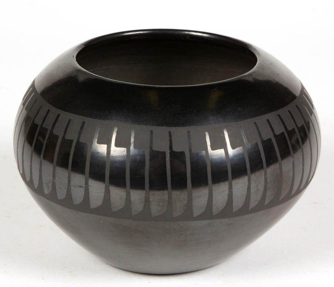 SIGNED MARIA POVEKA MARTINEZ (1884-1980) NATIVE: SIGNED MARIA POVEKA MARTINEZ (1884-1980) NATIVE AMERICAN SAN ILDEFONSO PUEBLO BLACKWARE POTTERY BOWL, squat form, featuring a band of matte painted feather-like designs encircling the body. Incised "M
