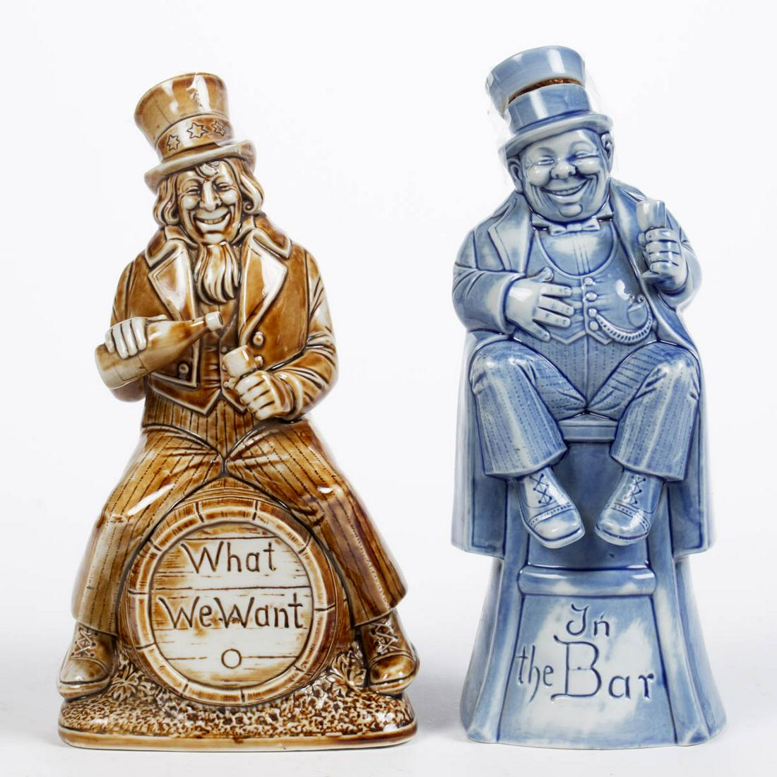 GERMAN SCHAFER & VATER PORCELAIN FIGURAL BOTTLES, LOT: GERMAN SCHAFER & VATER PORCELAIN FIGURAL BOTTLES, LOT OF TWO, comprising a blue-glazed example featuring a well-dressed chubby, jolly man sitting on a stool and holding a wine glass in left hand with