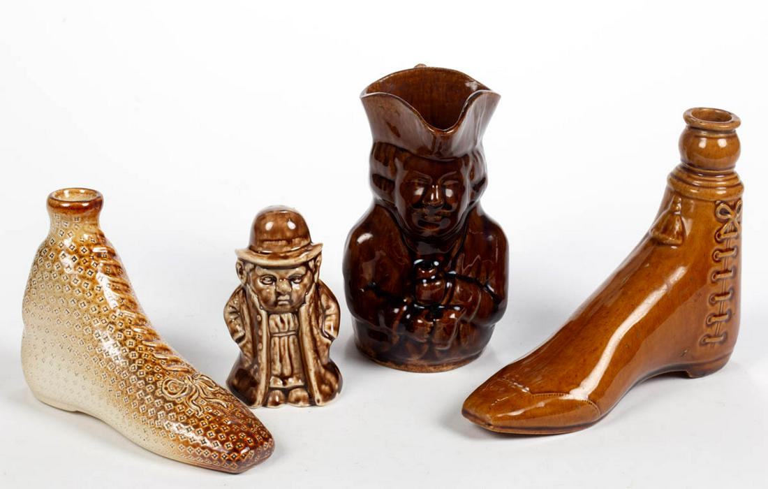 ASSORTED BROWN-GLAZED CERAMIC DRINKING ARTICLES, LOT OF: ASSORTED BROWN-GLAZED CERAMIC DRINKING ARTICLES, LOT OF THREE, comprising two figural boot flasks, including one salt-glazed example with molded laces and bow and one Rockingham-glaze example with mol