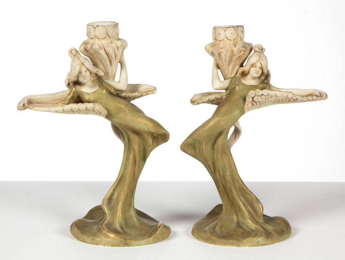 CZECHOSLOVAKIAN ROYAL DUX ART NOUVEAU PORCELAIN FIGURAL: CZECHOSLOVAKIAN ROYAL DUX ART NOUVEAU PORCELAIN FIGURAL PAIR OF CANDLESTICKS, each featuring a graceful woman wearing a flowing green dress/stem with gilt highlights, enchantingly resting against a lo
