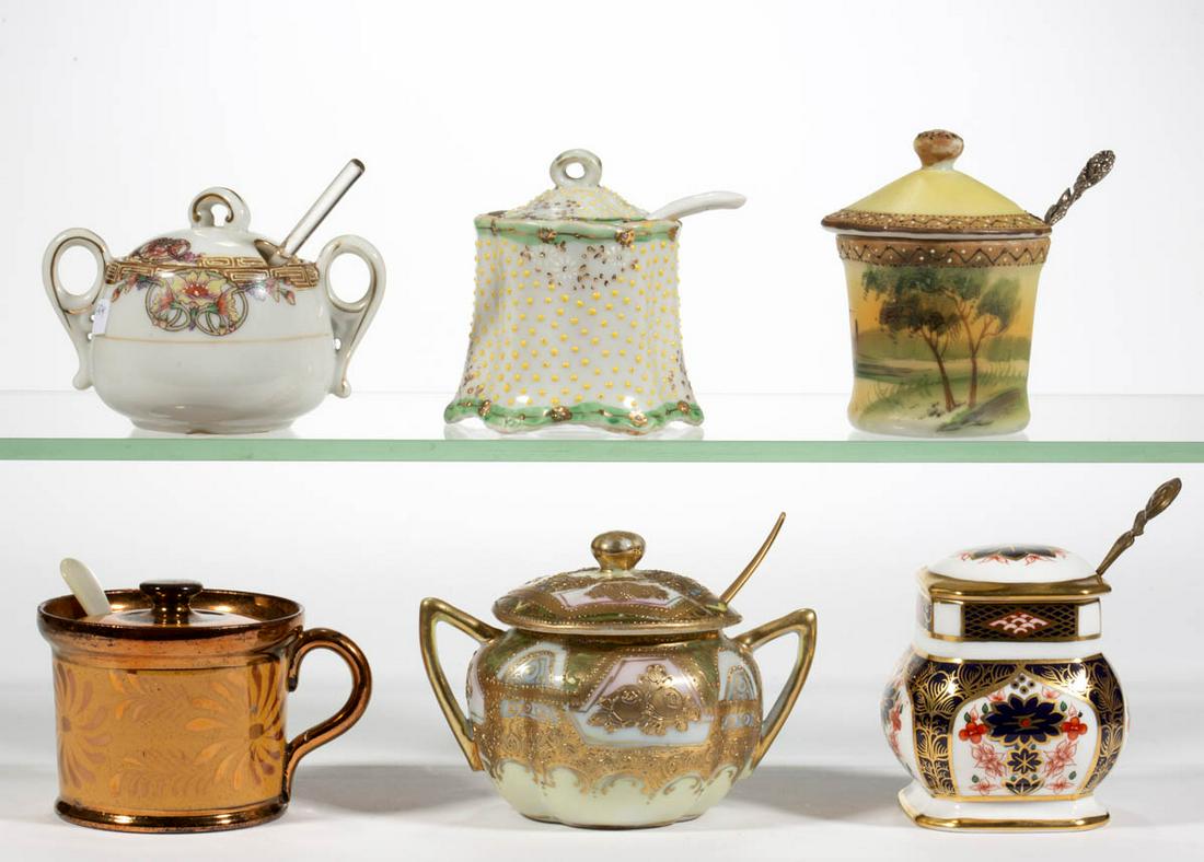 ASSORTED PORCELAIN COVERED MUSTARD POTS, LOT OF SIX: ASSORTED PORCELAIN COVERED MUSTARD POTS, LOT OF SIX, each fitted with a spoon, including two polychrome hand-painted Nippon examples, one featuring house in landscape on yellow ground and one with flo