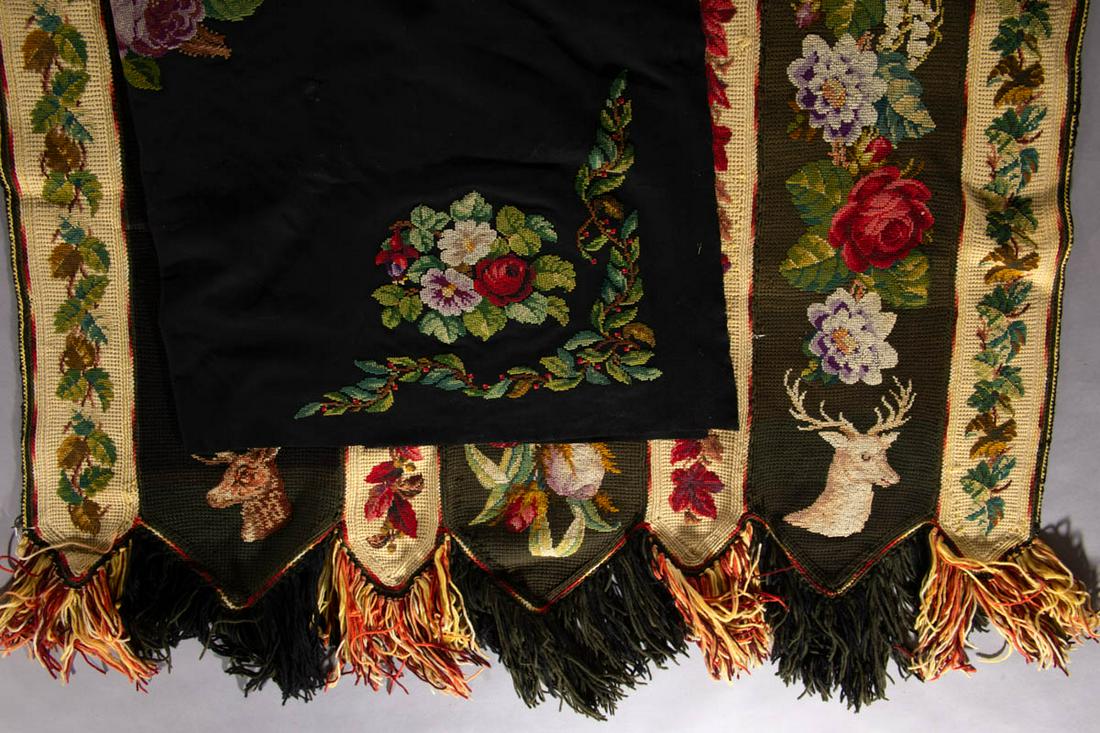 VICTORIAN NEEDLEWORK TABLE COVERS, LOT OF TWO: VICTORIAN NEEDLEWORK TABLE COVERS, LOT OF TWO, comprising a square black wool example having Berlinwork-type embroidered embellishments of a center medallion with cockatoo bird and four corner floral 
