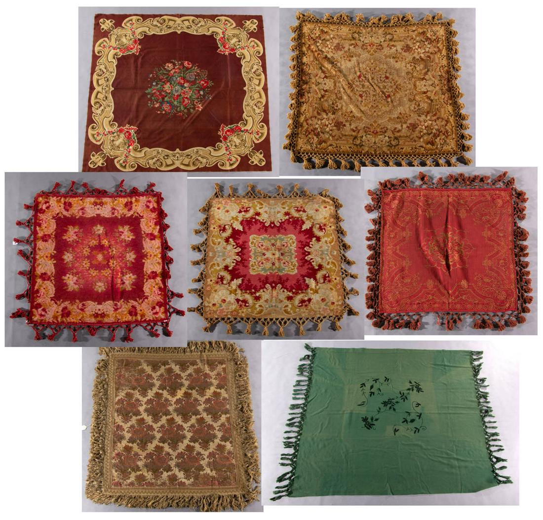 VICTORIAN TABLE COVERS, LOT OF SEVEN: VICTORIAN TABLE COVERS, LOT OF SEVEN, including an example with printed design featuring flowers in urns, a green fabric example with embroidered embellishments, and a brocade-type example with applie