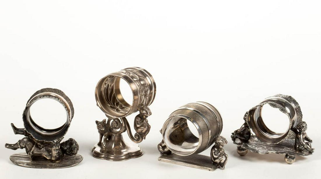 WILCOX SILVER PLATE CO. AND OTHER FIGURAL SILVER-PLATED: WILCOX SILVER PLATE CO. AND OTHER FIGURAL SILVER-PLATED NAPKIN RINGS, LOT OF FOUR, comprising two pieces by Wilcox Silver Plate Co. consisting of a number "01549" barefoot boy example and a number "01