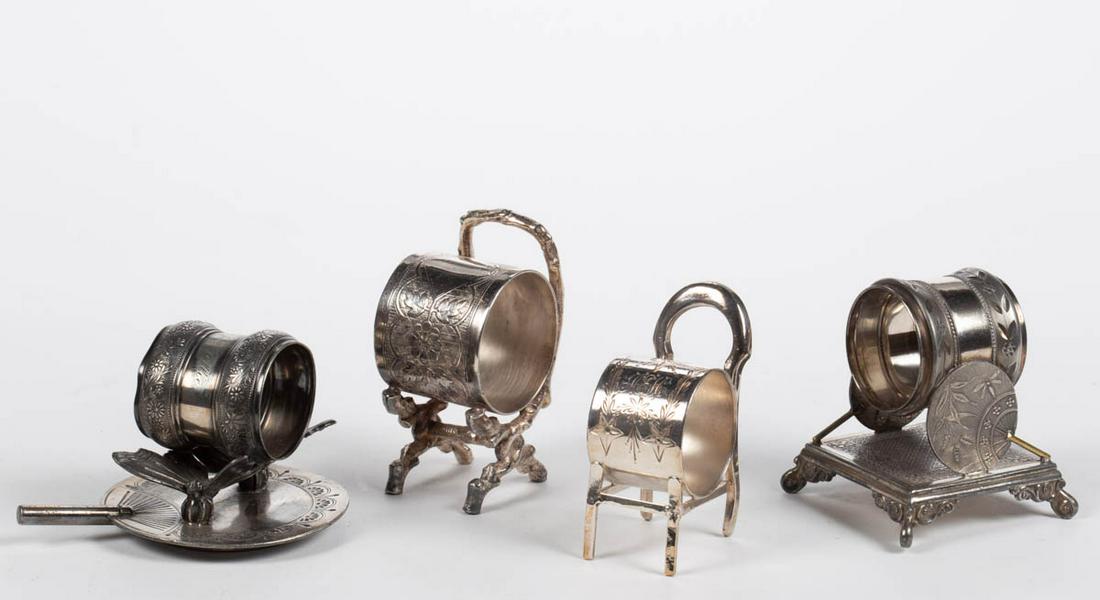 MERIDEN BRITANNIA CO. AND OTHER FIGURAL SILVER-PLATED: MERIDEN BRITANNIA CO. AND OTHER FIGURAL SILVER-PLATED NAPKIN RINGS, LOT OF FOUR, comprising a number "209" example by Meriden Britannia Co. featuring two butterflies on a fan, an unmarked double fan e