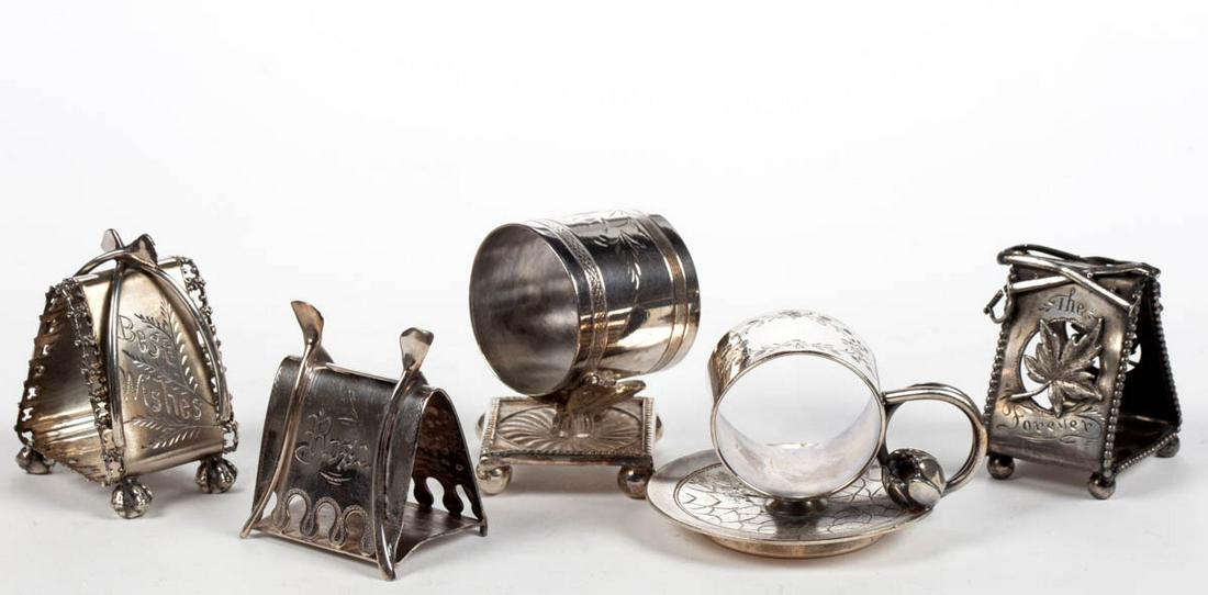 MERIDEN BRITANNIA CO. AND OTHER FIGURAL SILVER-PLATED: MERIDEN BRITANNIA CO. AND OTHER FIGURAL SILVER-PLATED NAPKIN RINGS, LOT OF FIVE, comprising a number "4347" example by Wilcox Silver Plate Co. with two wish bones featuring "Best Wishes" to one side a