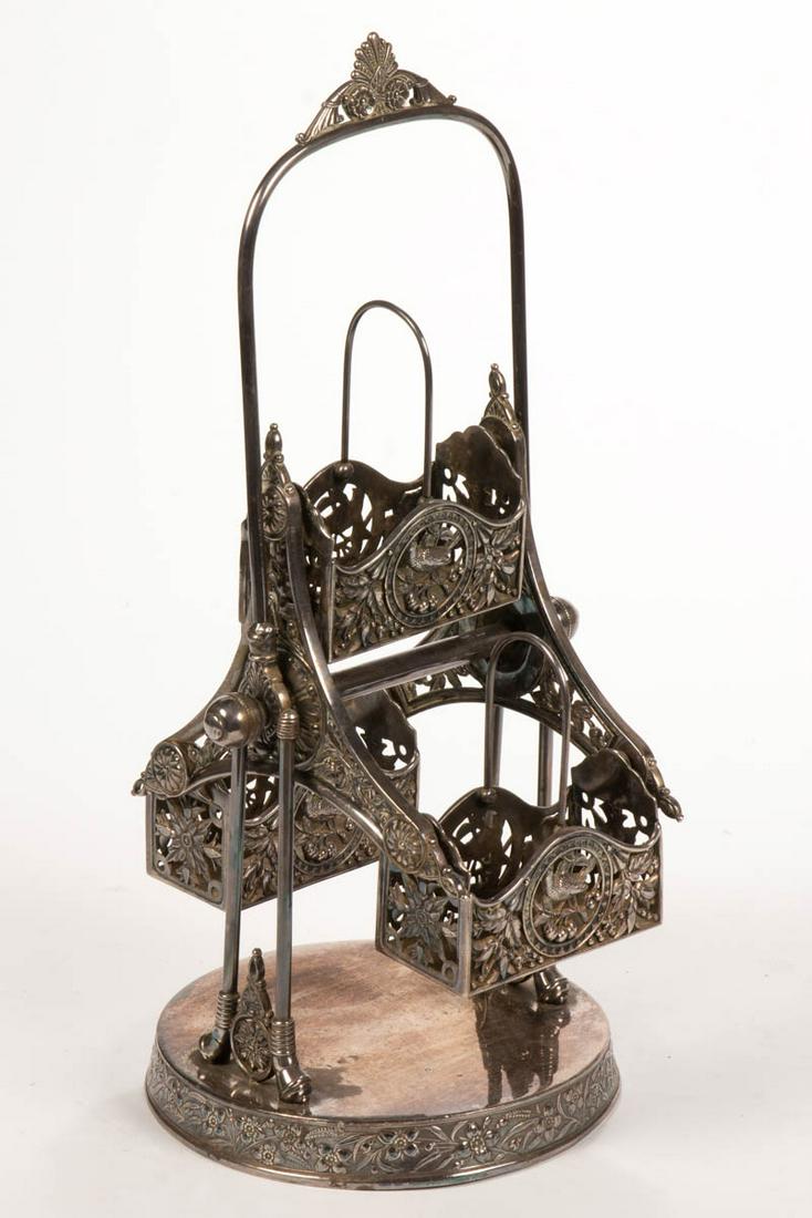 SIMPSON, HALL, MILLER & CO. SILVER-PLATED REVOLVING: SIMPSON, HALL, MILLER & CO. SILVER-PLATED REVOLVING FERRIS WHEEL CASTER / CONDIMENT HOLDER, having three individual reticulated baskets decorated with bird and foliate motifs, used for holding casters