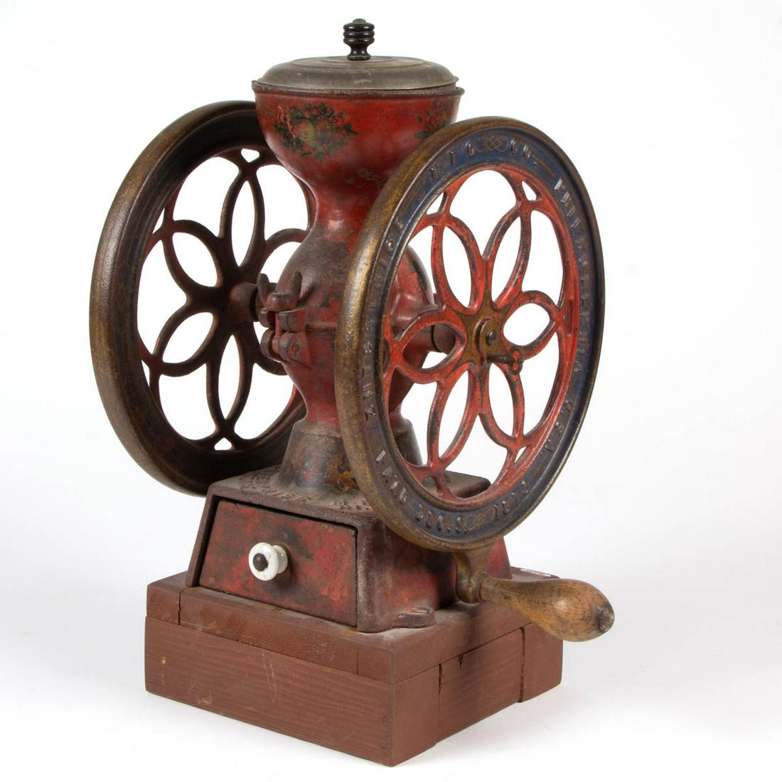 ENTERPRISE NO. 2 CAST-IRON TWO-WHEEL COFFEE MILL /: ENTERPRISE NO. 2 CAST-IRON TWO-WHEEL COFFEE MILL / GRINDER, non-original tin lid, later wooden base, original paint and decals. Enterprise Mfg. Co., Philadelphia, PA. Fourth quarter 19th century. 15" 