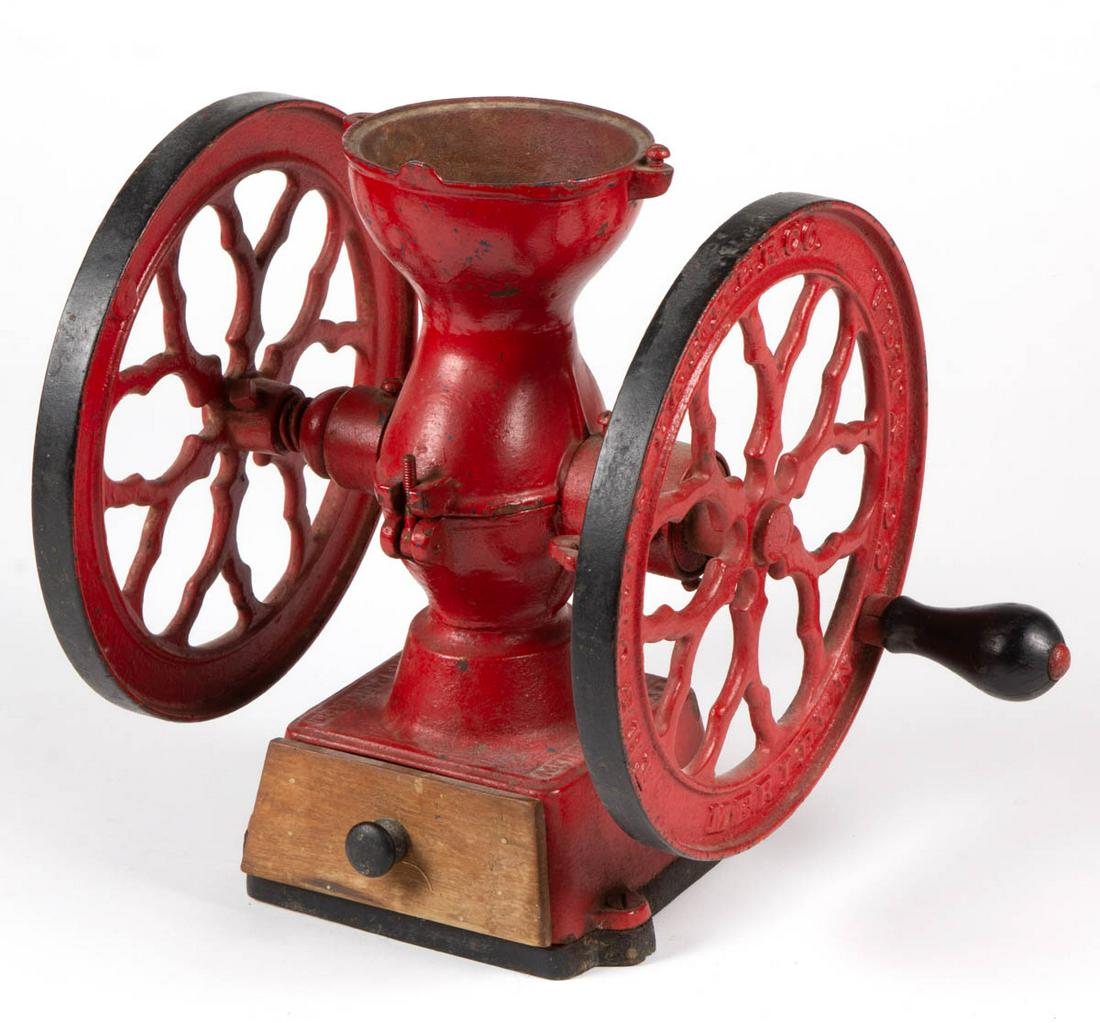 CHARLES PARKER CAST-IRON TWO-WHEEL COFFEE MILL /: CHARLES PARKER CAST-IRON TWO-WHEEL COFFEE MILL / GRINDER, lettering on wheels and body, wooden drawer, retains an old red-painted surface. Charles Parker Co., Meriden, CT. Fourth quarter 19th century.
