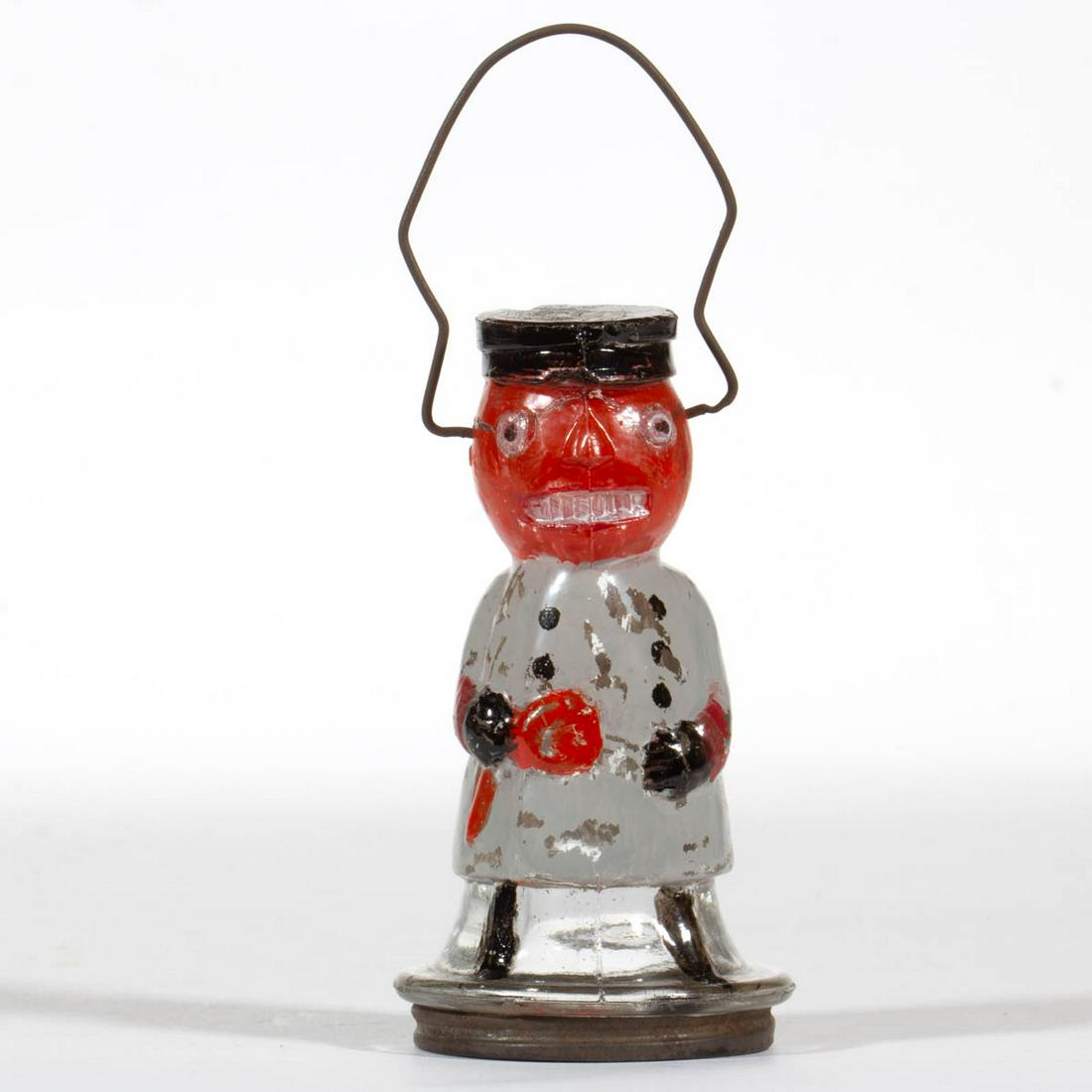 HALLOWEEN PUMPKIN HEAD JR. POLICEMAN FIGURAL GLASS: HALLOWEEN PUMPKIN HEAD JR. POLICEMAN FIGURAL GLASS CANDY CONTAINER, colorless with some paint, metal bail handle and screw closure. Circa 1920. 4 1/4" H figure. Top of hat with shallow chip and some f