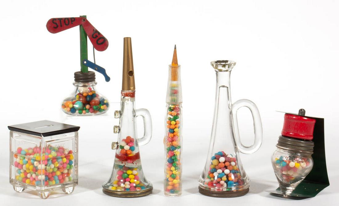 ASSORTED FIGURAL GLASS CANDY CONTAINERS, LOT OF SIX: ASSORTED FIGURAL GLASS CANDY CONTAINERS, LOT OF SIX, colorless, including "BABY JUMBO" Pencil, Stop and Go Signal, C.D. Kenny Savings Bank, and Spinning Top, four with original closure. First half 20t