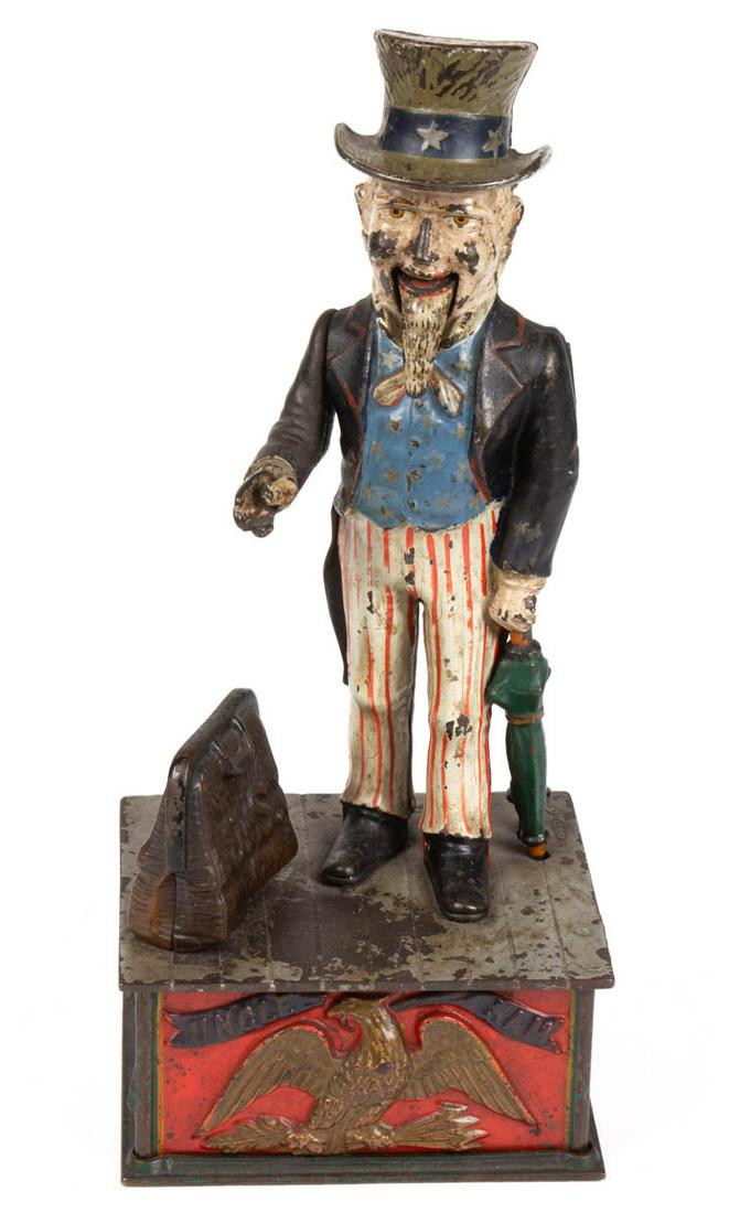 UNCLE SAM FIGURAL CAST-IRON MECHANICAL BANK: UNCLE SAM FIGURAL CAST-IRON MECHANICAL BANK, marked "PAT JUNE 1886" to base plate. Working condition in original paint. Shepard Hardware Co., Buffalo, NY. Circa 1886. 11 1/2" HOA. Minor to moderate ar
