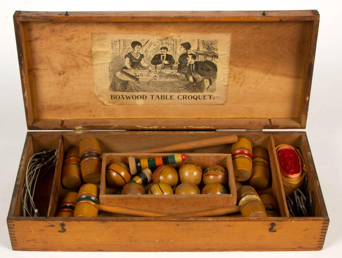 ANTIQUE CROQUET TABLE GAME: ANTIQUE CROQUET TABLE GAME, retaining original fitted box with an uncounted number of accessories, original printed label pasted to underside of lid for "BOXWOOD TABLE CROQUET". Fourth quarter 19th/ea