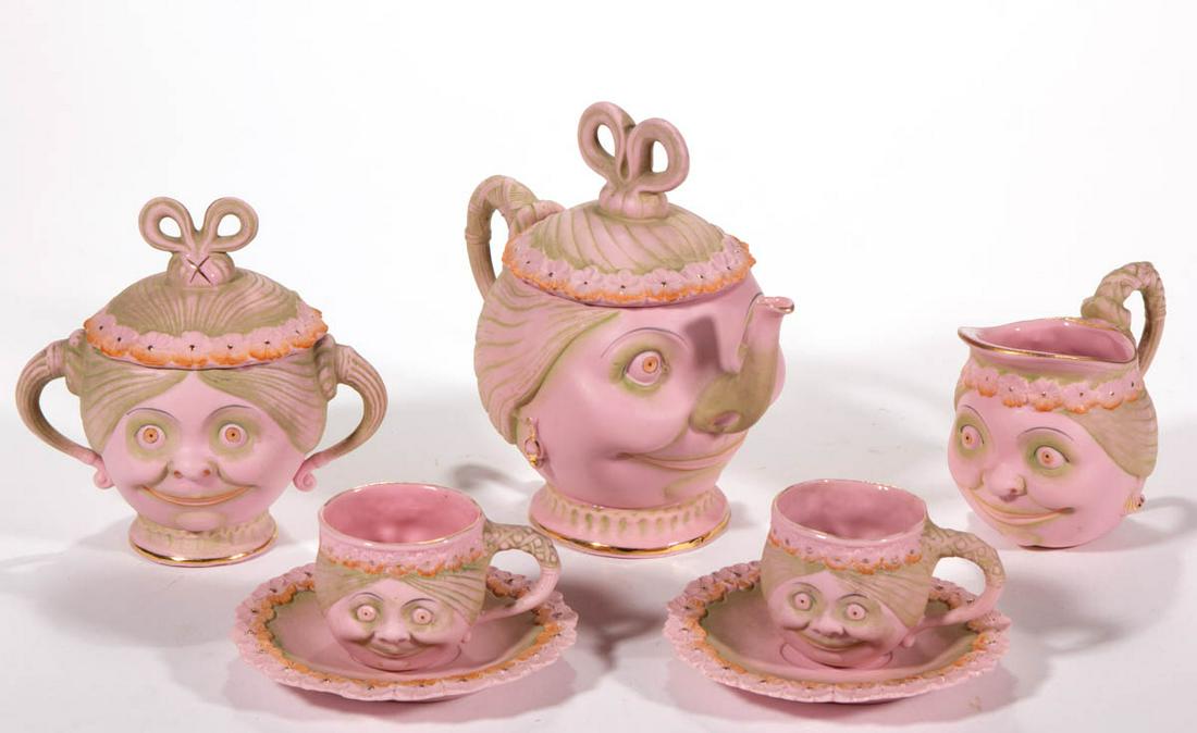 GERMAN SCHAFER & VATER BISQUE PORCELAIN SEVEN-PIECE: GERMAN SCHAFER & VATER BISQUE PORCELAIN SEVEN-PIECE CHILD'S TEA SET, comprising a teapot, a creamer, a covered sugar, and two cup and saucer sets, each molded in the likeness of a wide-eyed woman on p