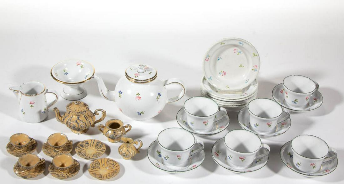 ASSORTED ENAMELED CHILD'S / TOY TEA SETS, LOT OF TWO: ASSORTED ENAMELED CHILD'S / TOY TEA SETS, LOT OF TWO, comprising a 21-piece set including a teapot, a compote, a pitcher, six cup and saucer sets, and six 3 1/2" D plates, each featuring charming poly