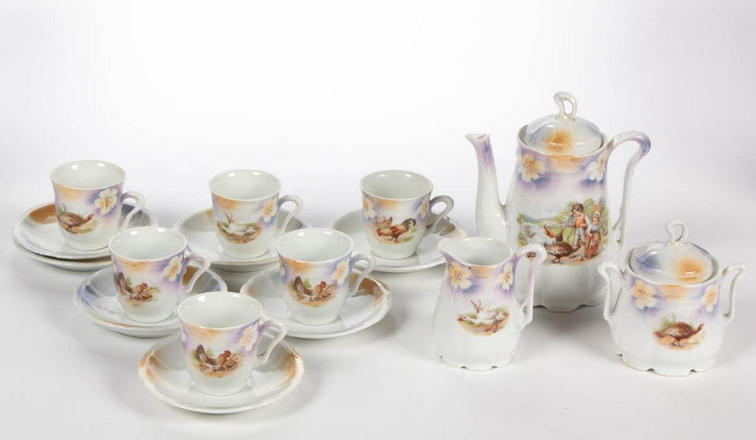 GERMAN PORCELAIN CHILDREN AND FOWLS MOTIF 16-PIECE: GERMAN PORCELAIN CHILDREN AND FOWLS MOTIF 16-PIECE CHILD'S TEA SET, comprising a teapot, a creamer, a covered sugar, six cups, and seven saucers, each having polychrome decals including children gathe