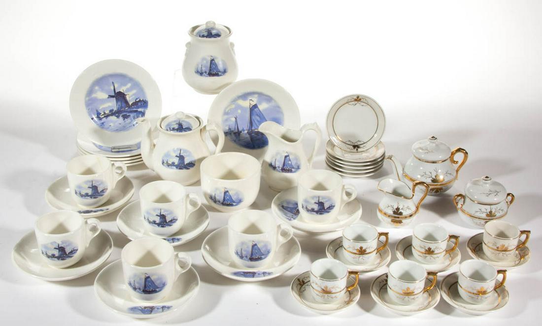 ASSORTED CERAMIC CHILD'S TEA SETS, LOT OF TWO: ASSORTED CERAMIC CHILD'S TEA SETS, LOT OF TWO, comprising a 22-piece set including teapot, creamer, covered sugar, waste bowl, six cup and saucer sets, and six plates, each having blue decal images fe