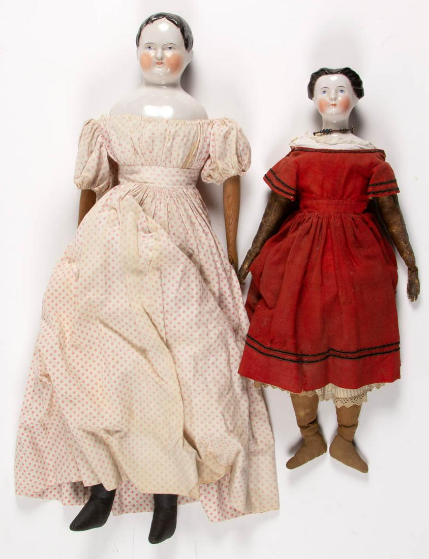 ASSORTED GERMAN CHINA SHOULDER-HEAD GIRL DOLLS, LOT OF: ASSORTED GERMAN CHINA SHOULDER-HEAD GIRL DOLLS, LOT OF TWO, painted facial features including blue eyes and painted eyebrows, closed mouths, molded black painted hair including a pulled back bun-style