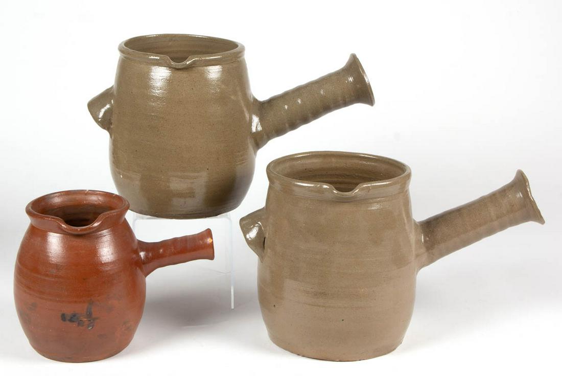 AMERICAN EARTHENWARE / REDWARE AND STONEWARE PIPKINS,: AMERICAN EARTHENWARE / REDWARE AND STONEWARE PIPKINS, LOT OF THREE, each having ovoid form with hollow protruding handle, comprising two salt-glazed stoneware examples, each with additional applied ar